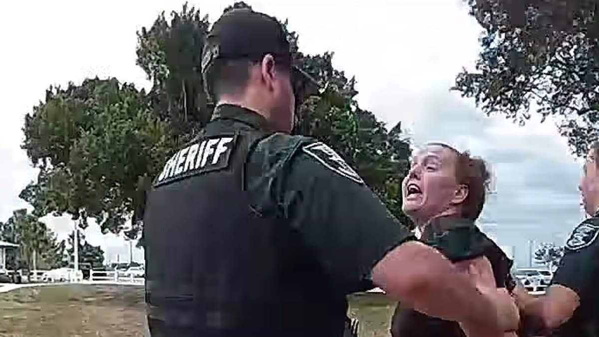 Florida mom's foul-mouthed arrest caught on camera as she is detained for 'storming the field and kicking a child' during youth football game