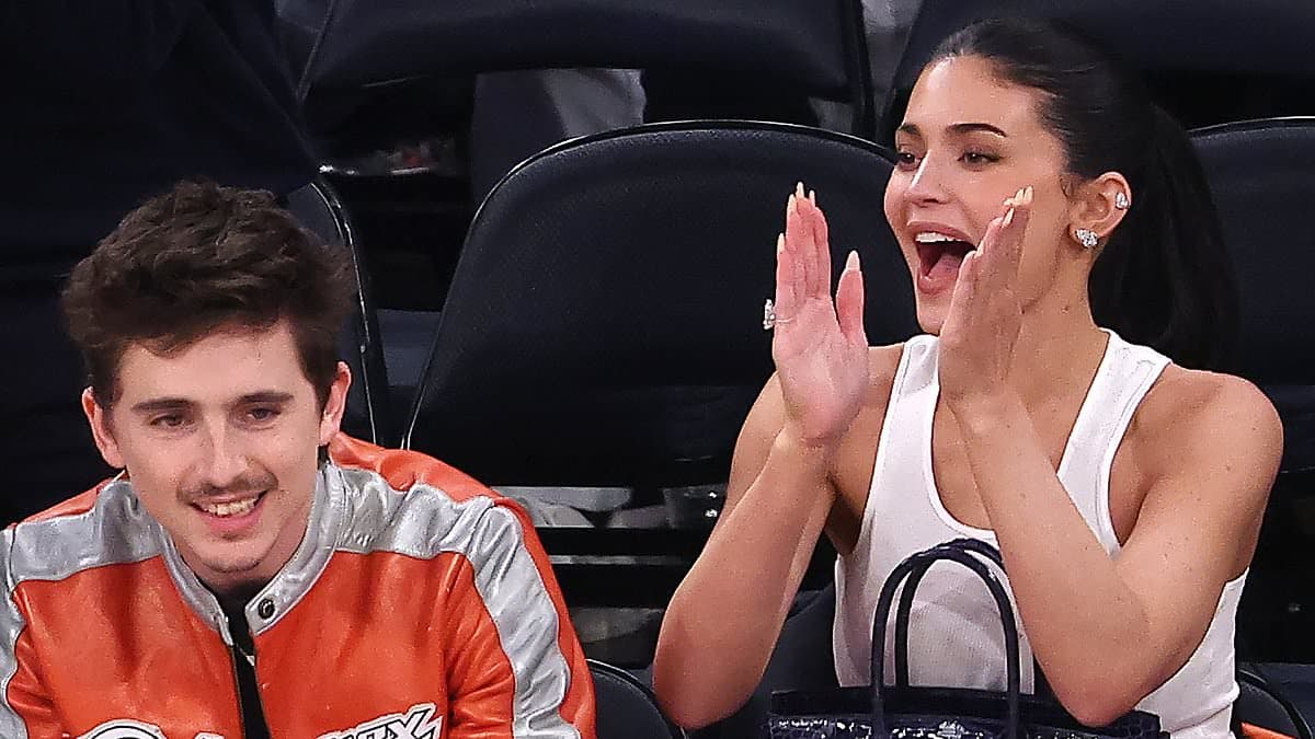 Kylie Jenner gets a kiss from Timothee Chalamet as she helps cheer on his beloved Knicks after he 'ditched' her at Met Gala
