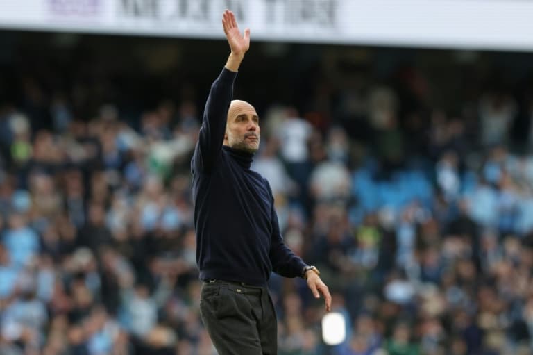 Guardiola warns title not won yet as Man City hunt down Arsenal