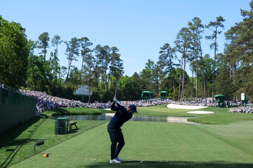 Defending champ Rory McIlroy excels in tough conditions to share Masters lead
