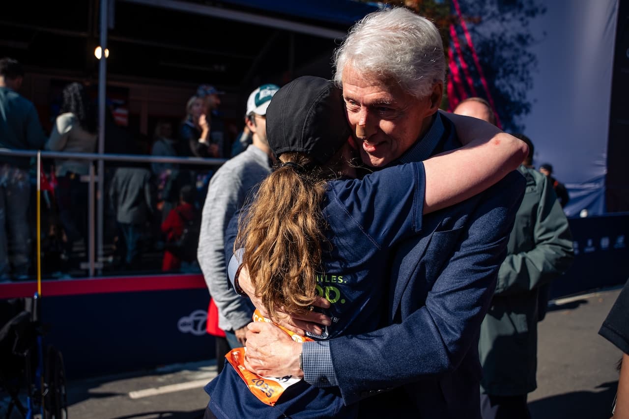 Bill and Hillary Clinton greet daughter Chelsea at finish line of Boston Marathon
