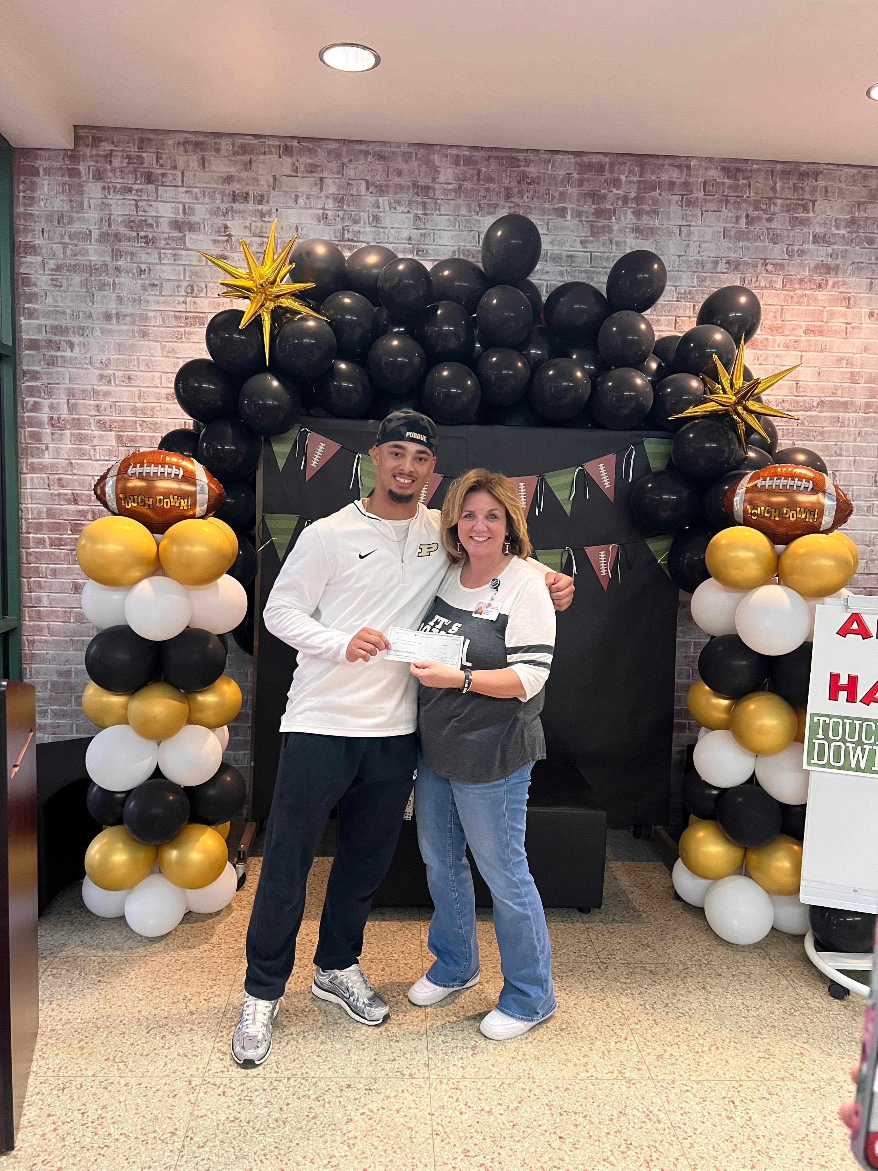 Purdue and former Castle running back Antonio Harris gives back