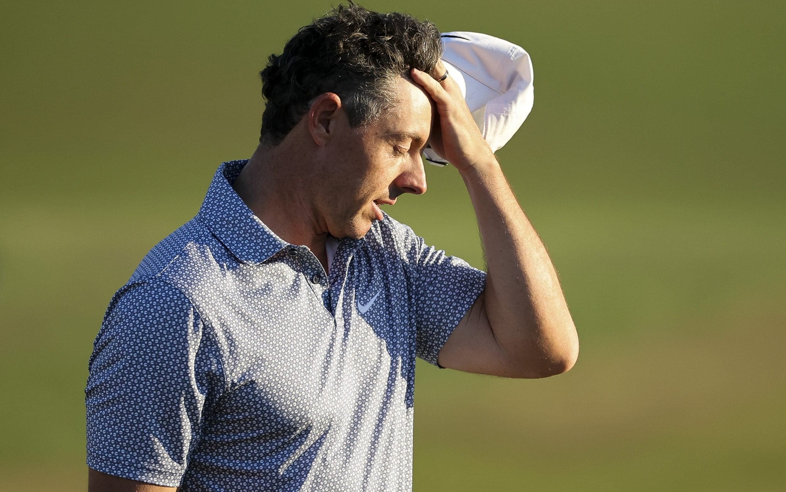 Rory McIlroy hangs on for share of lead after madcap third round